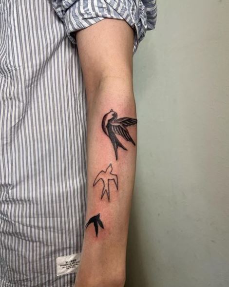 Black and White Family Swallow Forearm Tattoo