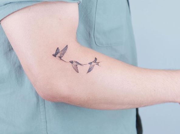 Three Grey Shaded Flying Swallows Arm Tattoo