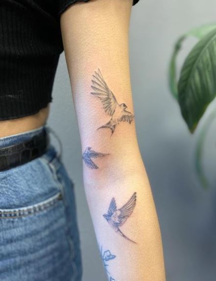 Family of Swallows Flying Arm Tattoo