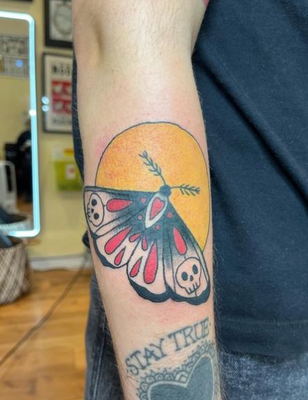 Sun Background and Colored Moth Forearm Tattoo