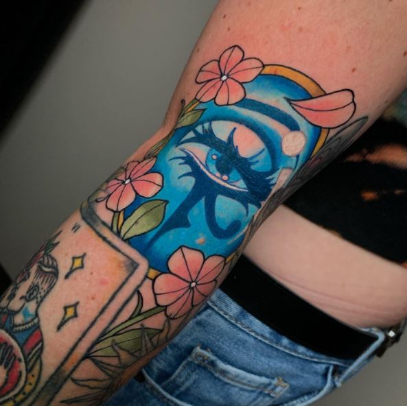 Flowers and Blue Colored Eye of Horus Tattoo