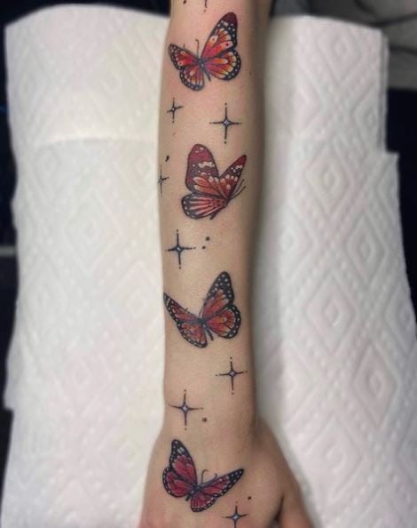 Stars and Red Butterflies Forearm Tattoo