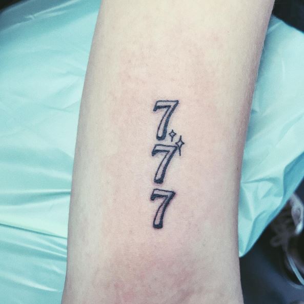 Grey Stars and 777 Arm Tattoo