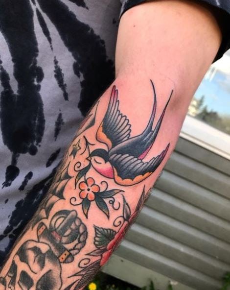 Flowers and Flying Swallow Forearm Tattoo