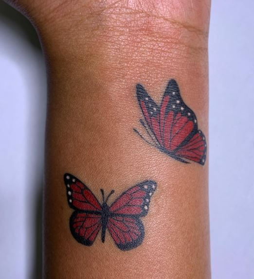 Couple of Small Red Monarch Butterflies Wrist Tattoo