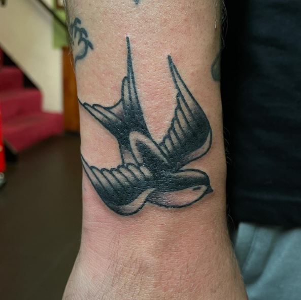 Black Inked Flying Swallow Tattoo