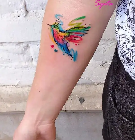 Vibrant Colored Hummingbird Tattoo on Elbow