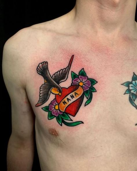 Black Swallow Chest Tattoo with Hearth and Flowers