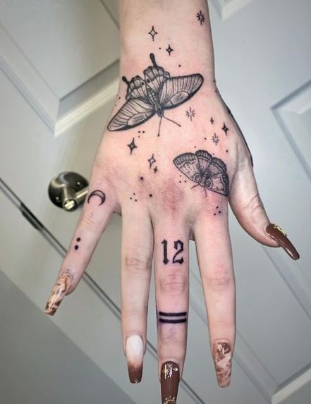 Black and Grey Stars and Moth Hand Tattoo