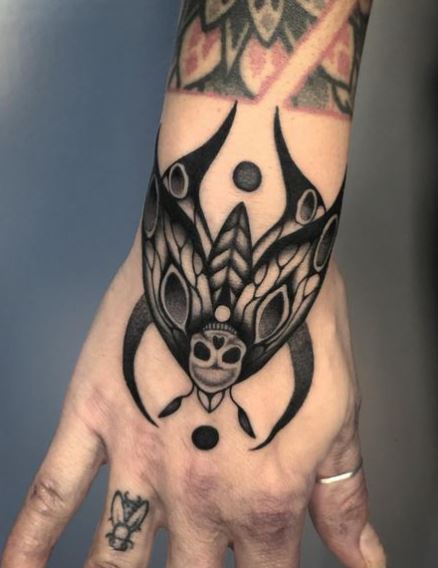 Black Half Moon and Moth Hand Tattoo