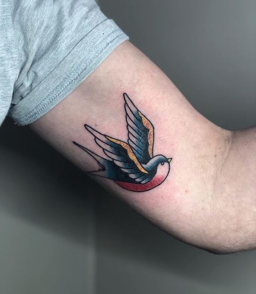 Colored Flying Swallow Biceps Tattoo