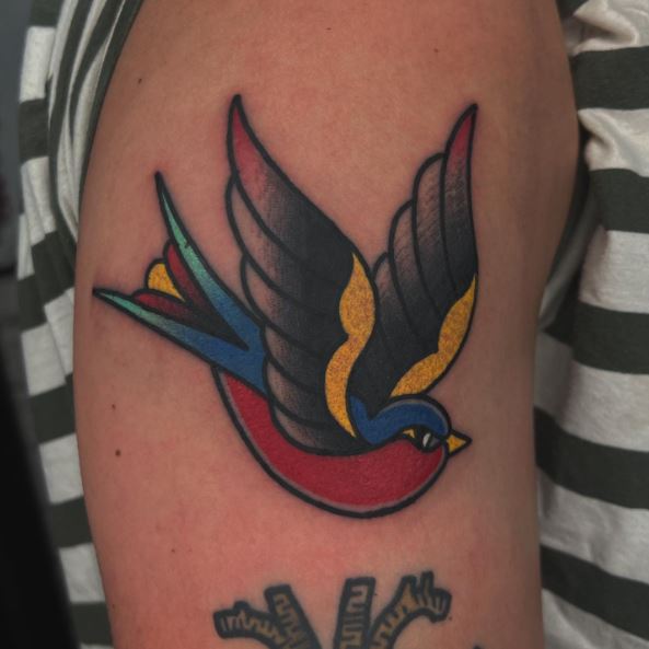 Colorful Swallow with Wings Up Tattoo