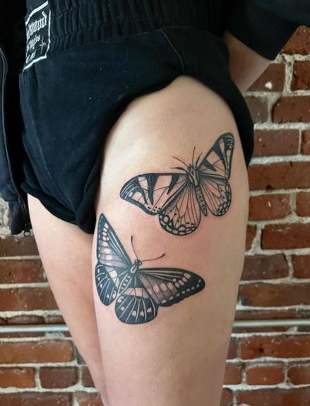 Two Big Grey Moths Thigh Tattoo