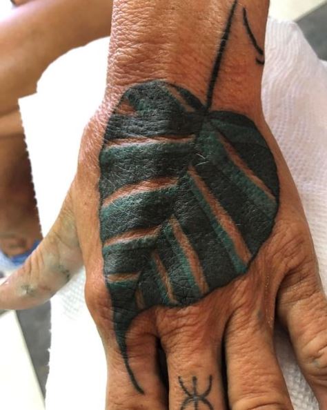 Black and Green Bodhi Leaf Hand Tattoo