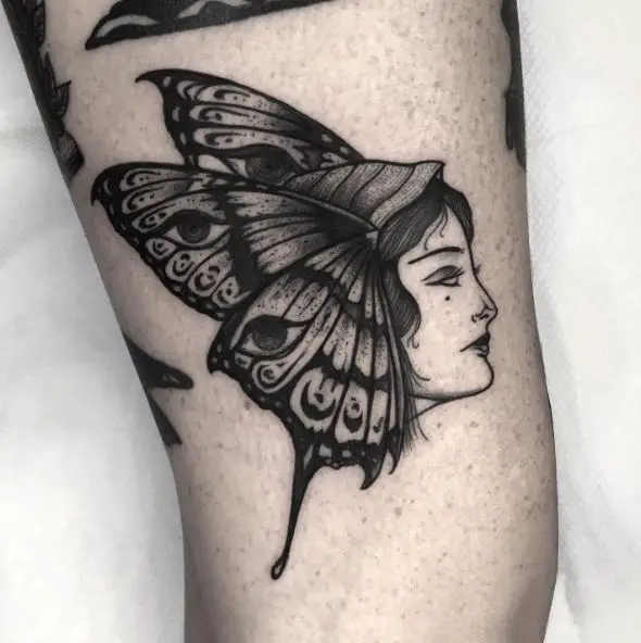 Grey Woman Face Moth Thigh Tattoo