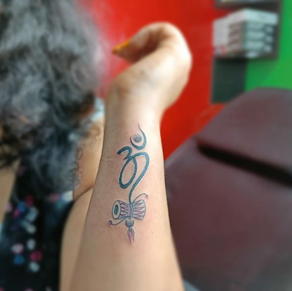 Om with Damru Forearm Tattoo