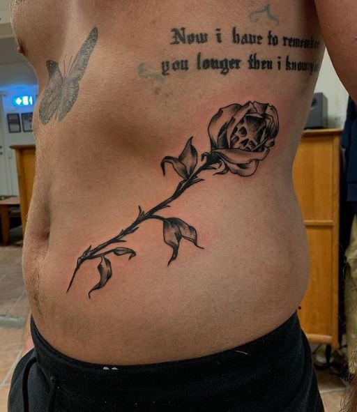 Black Inked Rose and Skull Belly Tattoo