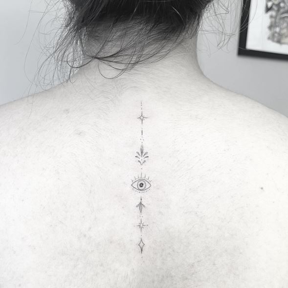 Ornaments and Evil Eye Spine Tattoo