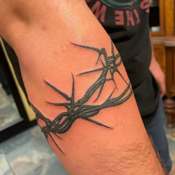 Arm Wrapped Bold Inked Barbed Wire Tattoo