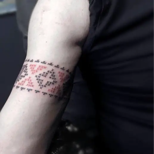 Black and Red Cross Stitch Tattoo on Arm