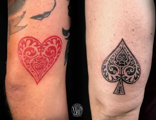 Red heart and spade tattoo on Legs