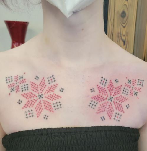 Green and Red Floral Cross Stitch Tattoo on Chest