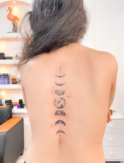 Greyscale Phases of the Moon Spine Tattoo