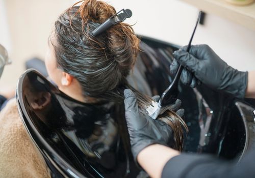 Hairdresser Applying Hair Protector