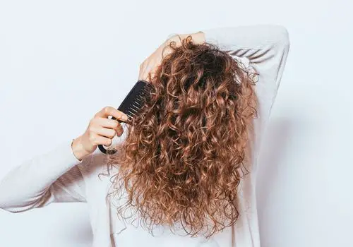 Woman Combing Her Curly Hair