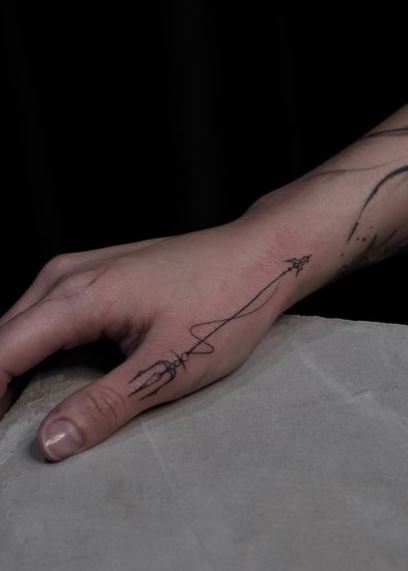 Minimalistic Trident Thumb Tattoo