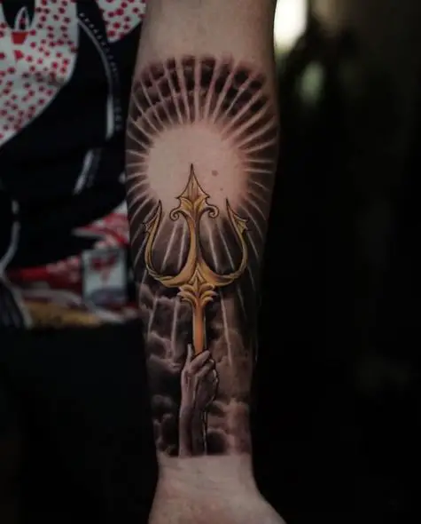Hand holding Golden Trident Tattoo