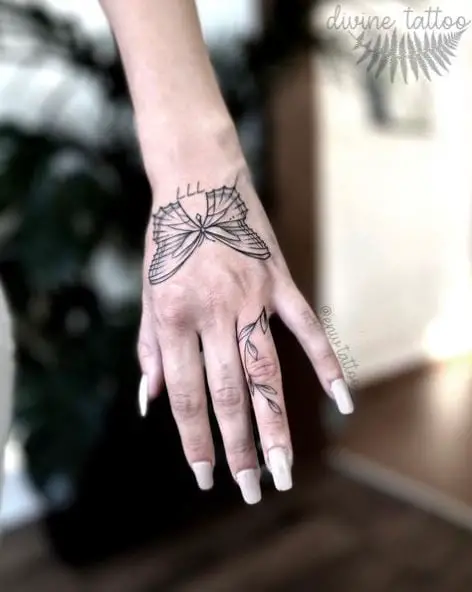 Grey Butterfly and 777 Hand Tattoo