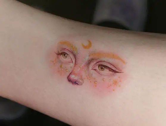 Face and Crescent Moon Tattoo