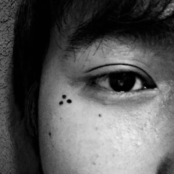 Simple and Bold Three Dots Tattoo on the Face