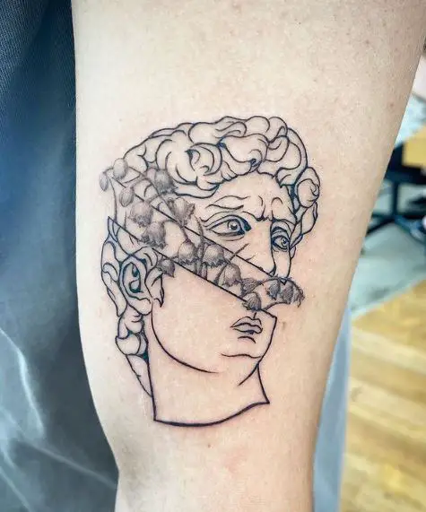 Tattoo of Shaded Lily of the Valley Flowers in the Split Head Statue