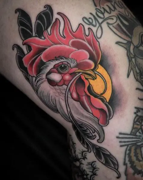 Tattoo of a Black and Grey Rooster and Red Comb Wattles