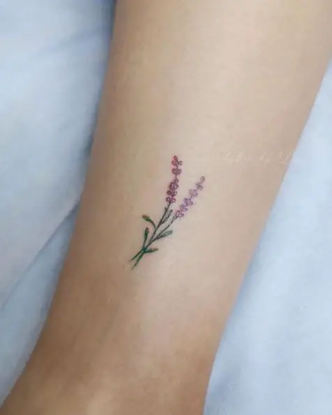 Tiny Reddish Lavender Flower Tattoo