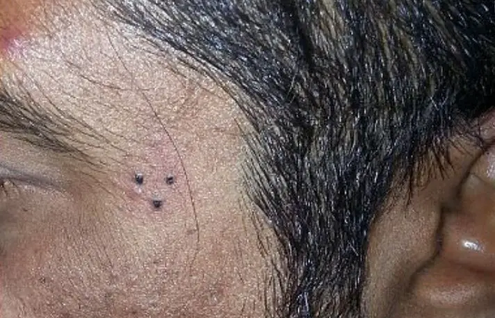 Triangle Three Dots Tattoo Near Eyebrow