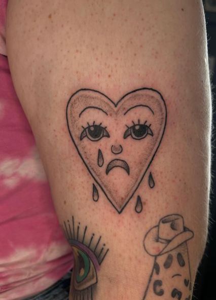 Grey Shaded Crying Heart Arm Tattoo