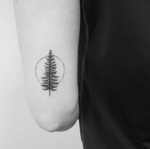 Circle and Pine Tree Elbow Tattoo