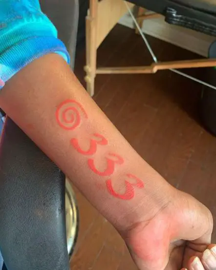 Red Spiral and 333 Forearm Tattoo