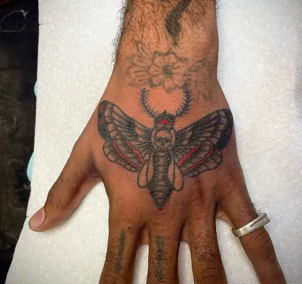 Black and Red Death Moth Hand Tattoo