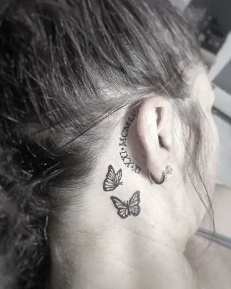 Behind the Ear Roman Numerals and Teeny Weeny Butterflies Tattoo