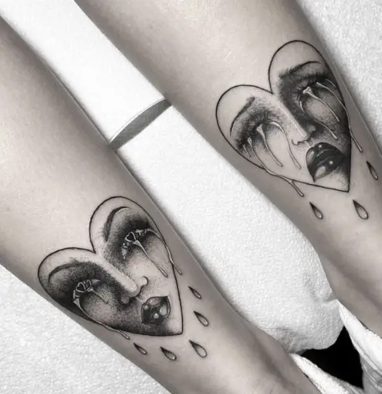 Black and Grey Crying Hearts Faces Tattoo