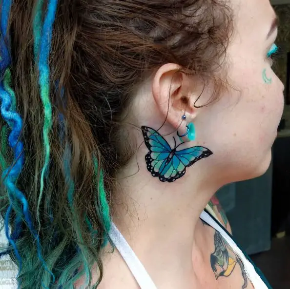 Blue and Black Butterfly Tattoo Behind the Ear