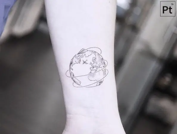 Globe and Paper Plane Wrist Tattoo