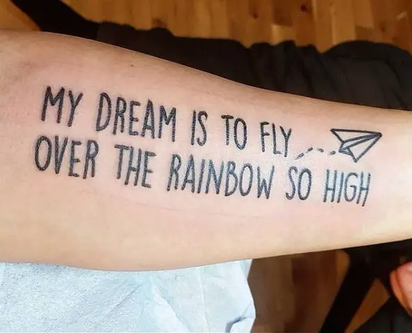 Large Quote and Small Paper Plane Tattoo