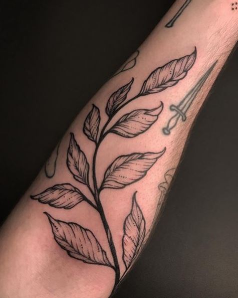 Leaf tattoo on the left inner arm