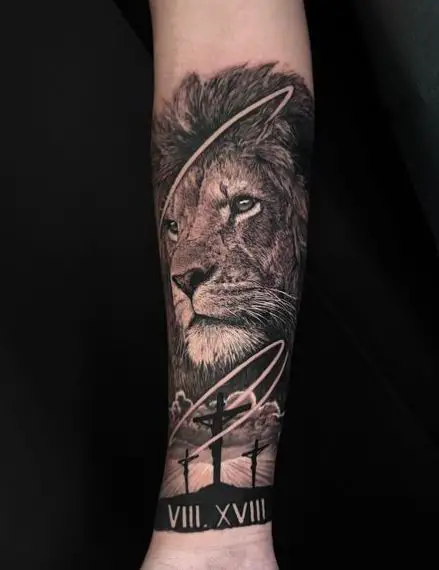 Lion’s portrait and three cross tattoo