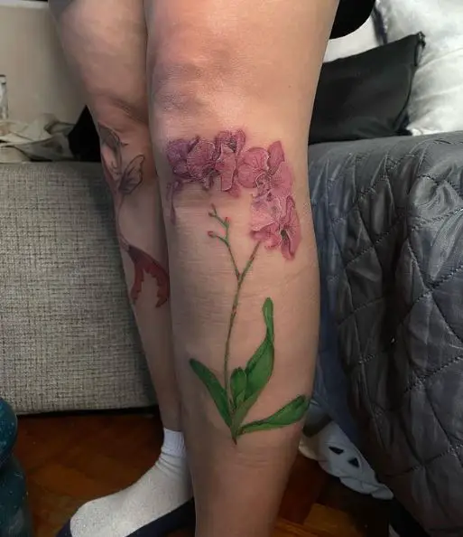 Orchid Flowers and Green Leaves Knee Tattoo